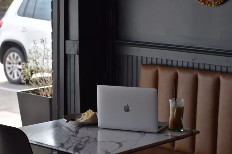 A laptop and cake on a table at B-Side Coffee.